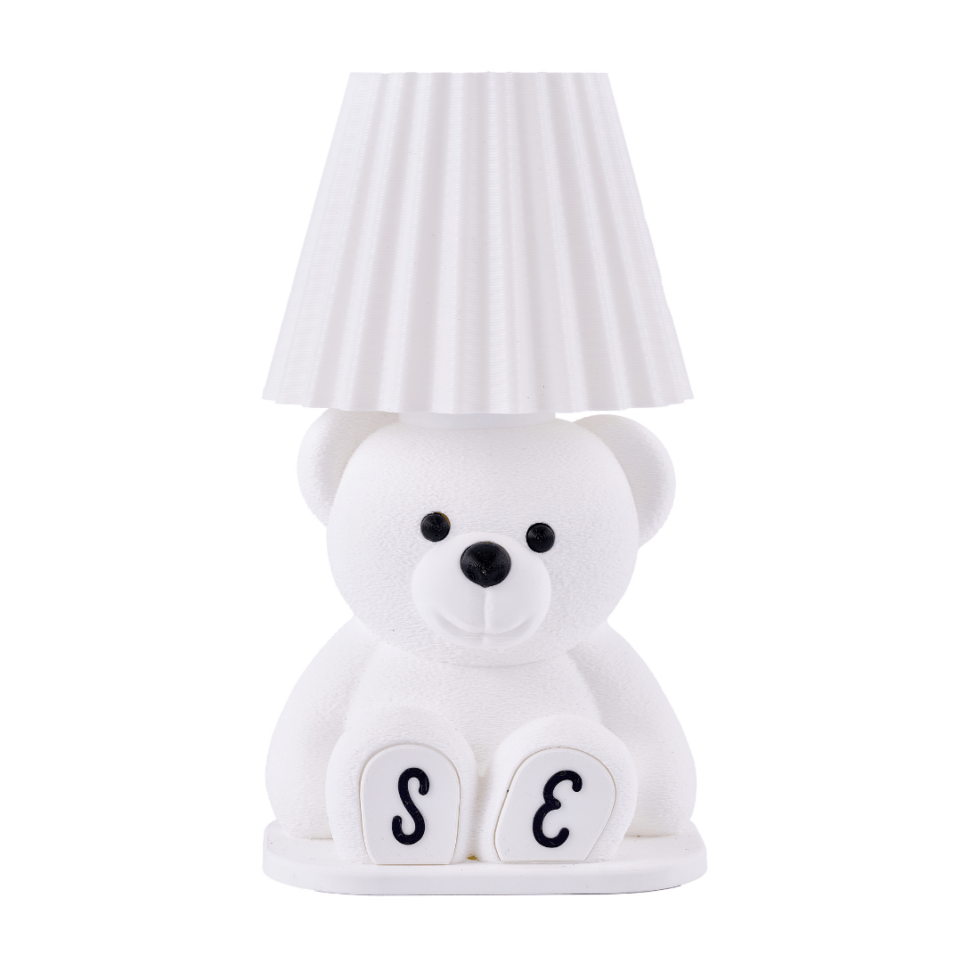 White teddy bear-shaped lamp with a striped lampshade on a white background