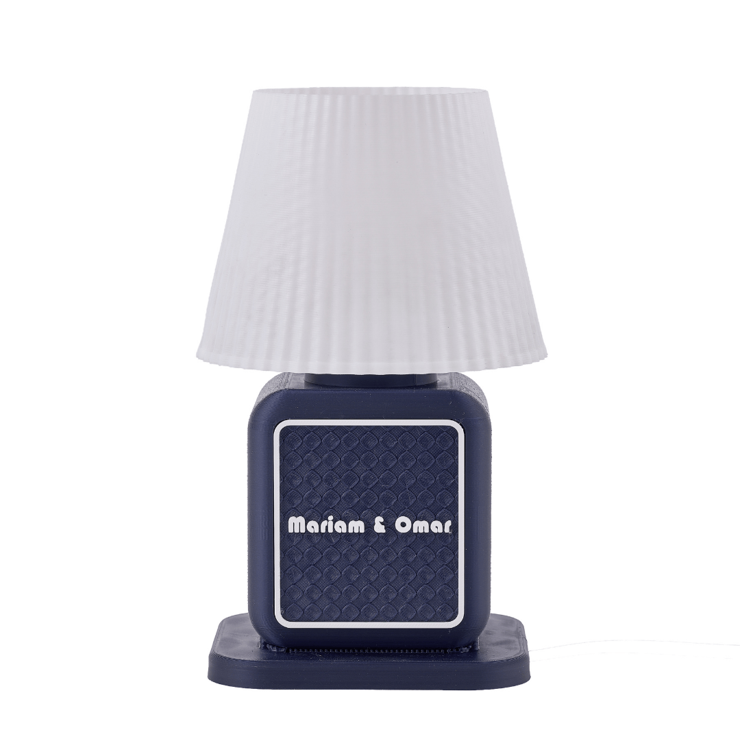 Navy blue lamp with white textured shade on a white background