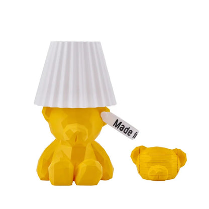Yellow teddy boi bear-shaped lamp and a matching coasters with a white shade on a white background