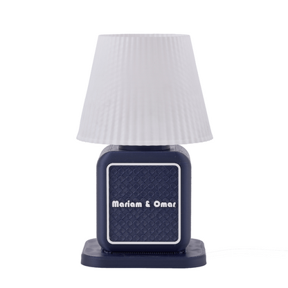 Navy blue lamp with white textured shade on a white background