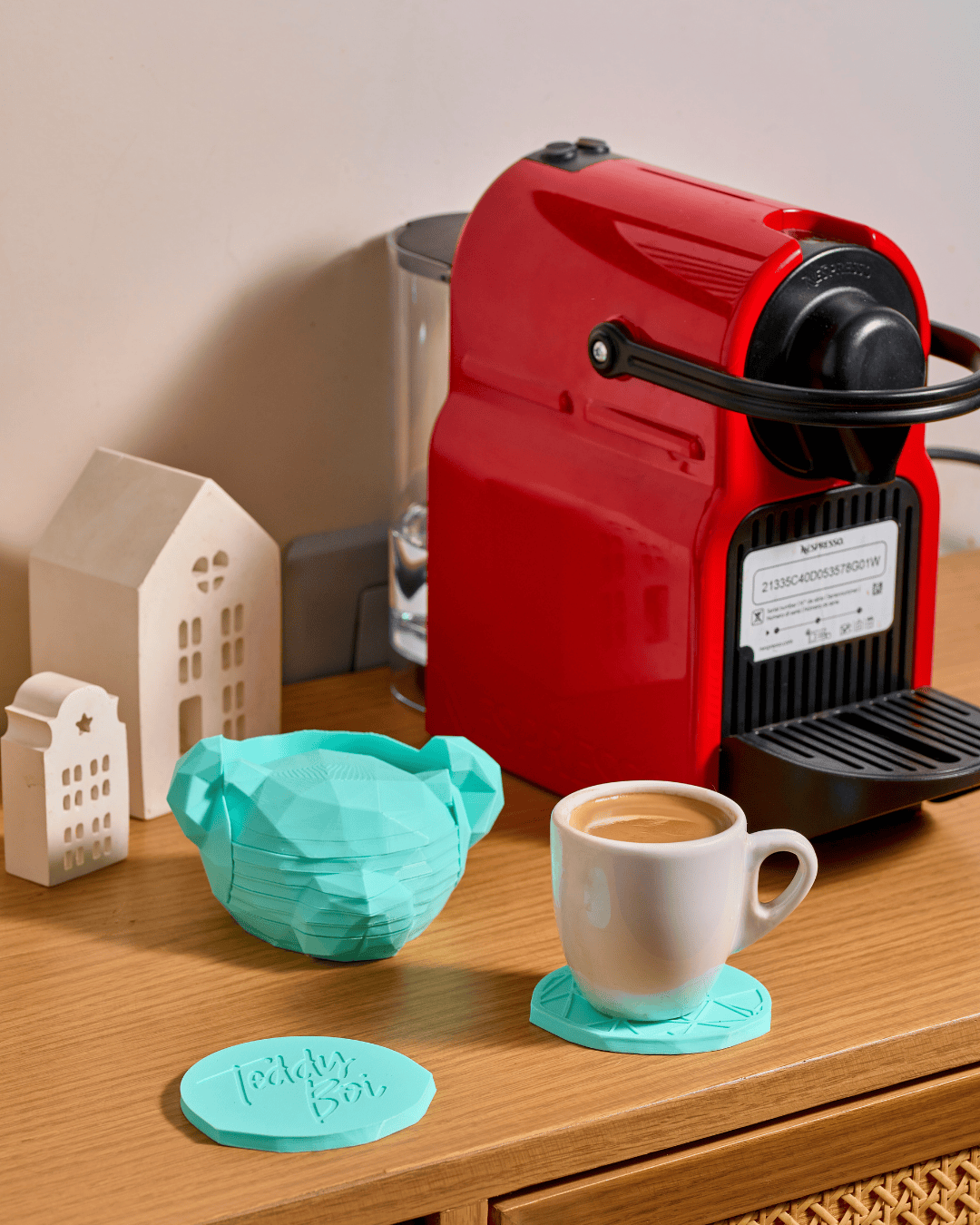 3D printed modern geometric Teddy Boi coasters with a faceted docking holder on a coffee table
