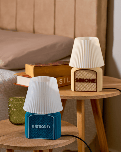 3D printed Art Deco table lamps with geometric lattice design and customized raised nameplate in a wooden tables 