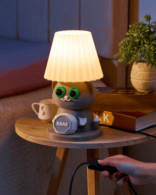 Cat-shaped night light on a wooden table with a blurred background